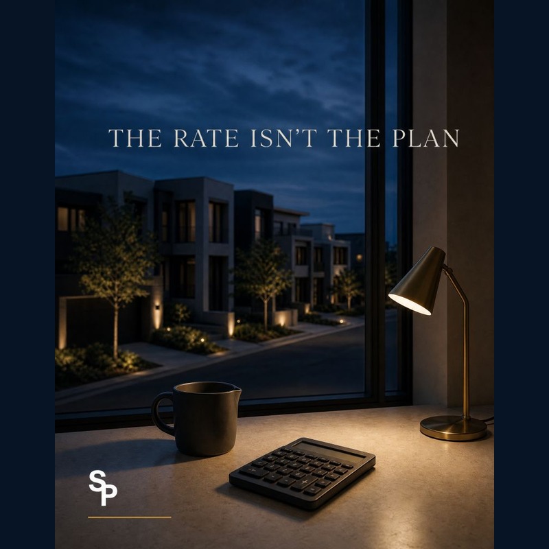 Square original Solara LinkedIn creative reading The Rate Isn’t the Plan, with a calculator, desk lamp and dusk residential street view